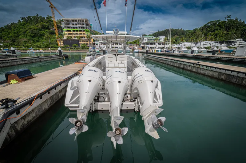 Half Nelson Yacht Photos Pics A 2016 Jupiter HFS boat with triple Yamaha engines docked in a marina.