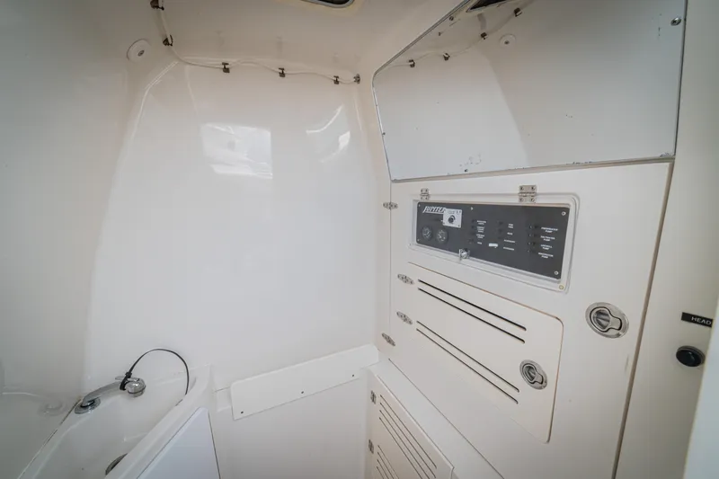 Half Nelson Yacht Photos Pics 2016 Jupiter HFS boat interior with control panel and storage compartments.