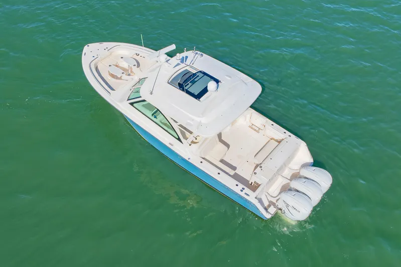  Yacht Photos Pics 2019 Grady-White Freedom 375 boat on clear green water, aerial view.