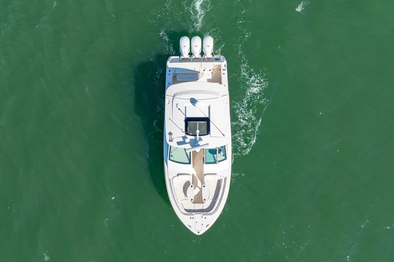  Yacht Photos Pics Aerial view of 2019 Grady-White Freedom 375 boat cruising on green water.