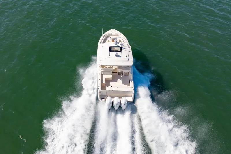  Yacht Photos Pics 2019 Grady-White Freedom 375 boat cruising on open water, rear view.