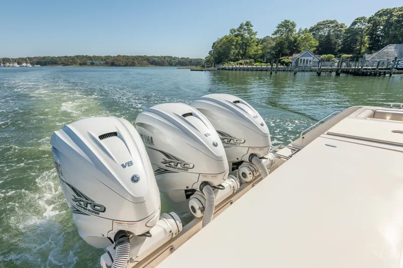  Yacht Photos Pics 2019 Grady-White Freedom 375 boat with triple Yamaha outboard engines on a scenic waterway.