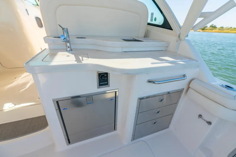  Yacht Photos Pics 2019 Grady-White Freedom 375 boat interior with kitchenette and storage drawers.