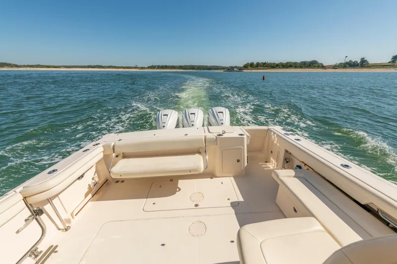  Yacht Photos Pics 2019 Grady-White Freedom 375 boat cruising on open water, showcasing spacious deck.