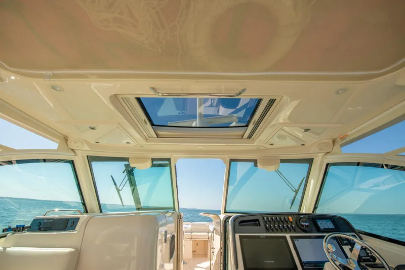  Yacht Photos Pics Interior view of 2019 Grady-White Freedom 375 boat cockpit with ocean backdrop.