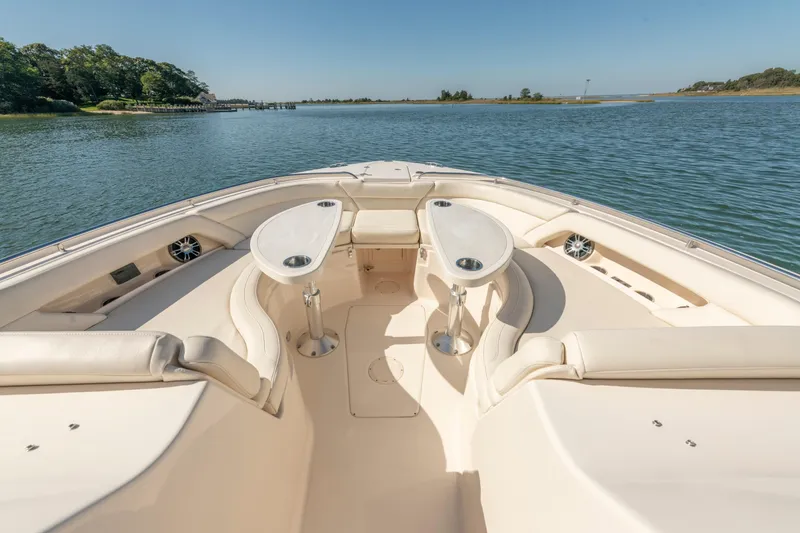  Yacht Photos Pics 2019 Grady-White Freedom 375 boat interior with seating and tables on calm water.