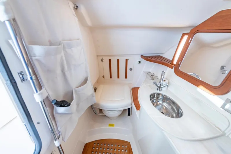  Yacht Photos Pics 2019 Grady-White Freedom 375 boat bathroom with sink, mirror, and storage.