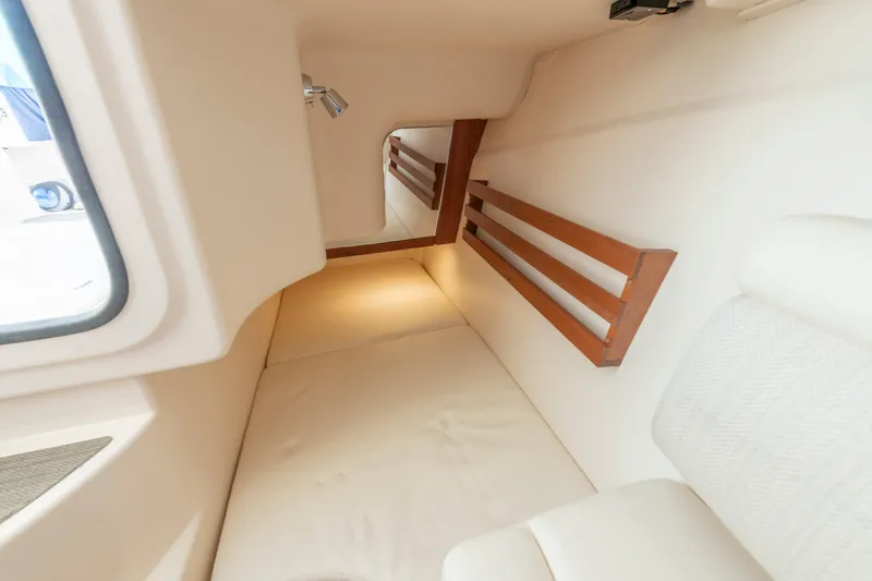  Yacht Photos Pics 2019 Grady-White Freedom 375 cabin interior with cozy bed and wooden accents.