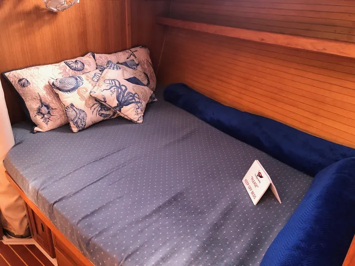 Papa Bob Yacht Photos Pics Cozy cabin bed in 1996 Catalina 42 MkII sailboat with nautical-themed pillows.