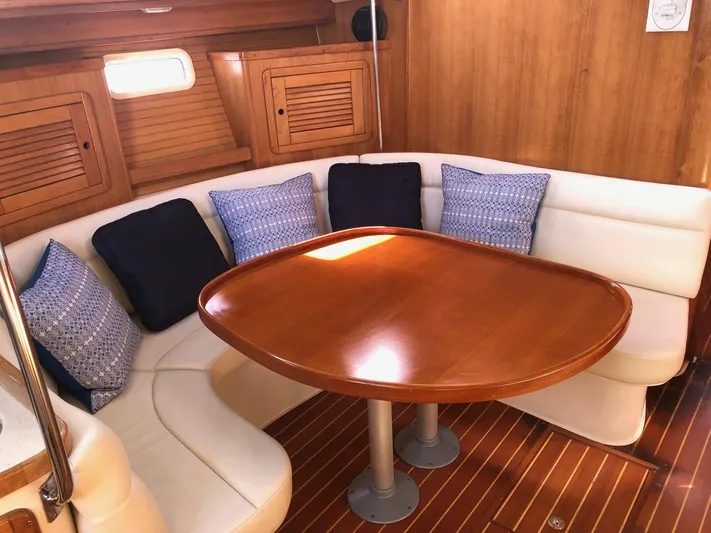 Papa Bob Yacht Photos Pics Cozy dining area in 1996 Catalina 42 MkII sailboat with wooden table and cushioned seating.