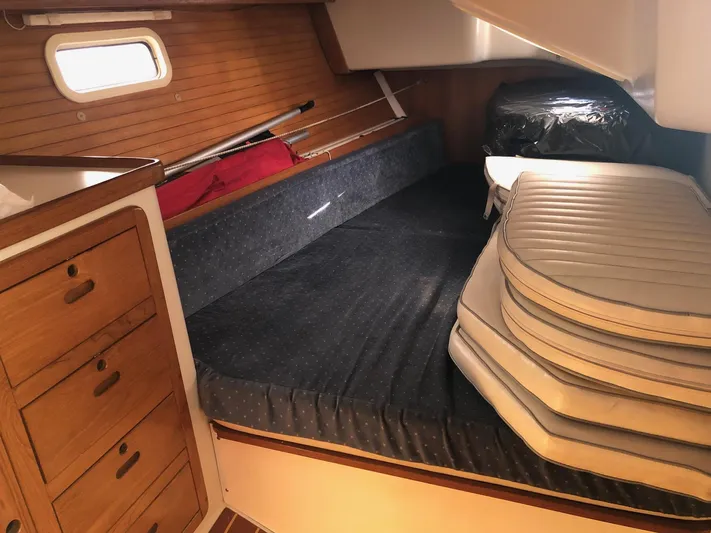 Papa Bob Yacht Photos Pics Interior cabin of 1996 Catalina 42 MkII sailboat with stacked cushions and wooden cabinetry.