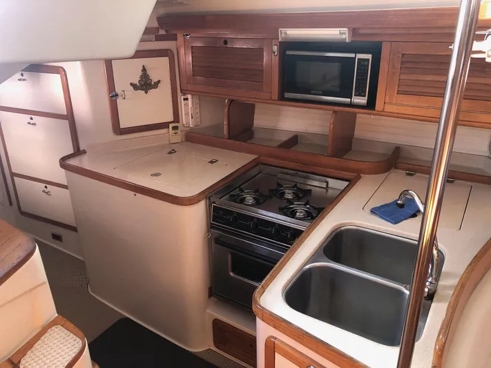 Papa Bob Yacht Photos Pics Interior of 1996 Catalina 42 MkII yacht kitchen with stove, sink, and microwave.
