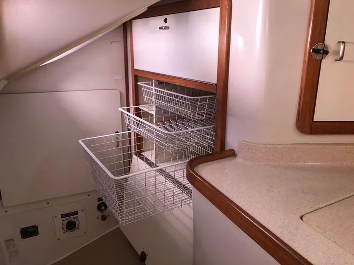 Papa Bob Yacht Photos Pics Interior storage with wire baskets in a 1996 Catalina 42 MkII sailboat.