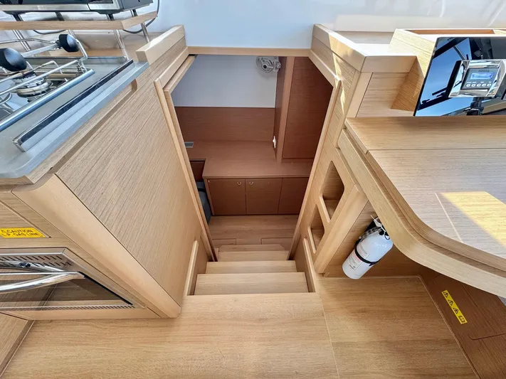 Sea SeÑora Yacht Photos Pics Interior of 2023 Excess 12 yacht, featuring wooden stairs and modern kitchen area.