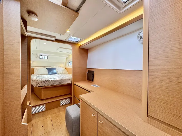 Sea SeÑora Yacht Photos Pics Interior of 2023 Excess 12 yacht featuring a cozy bedroom and modern wooden furnishings.