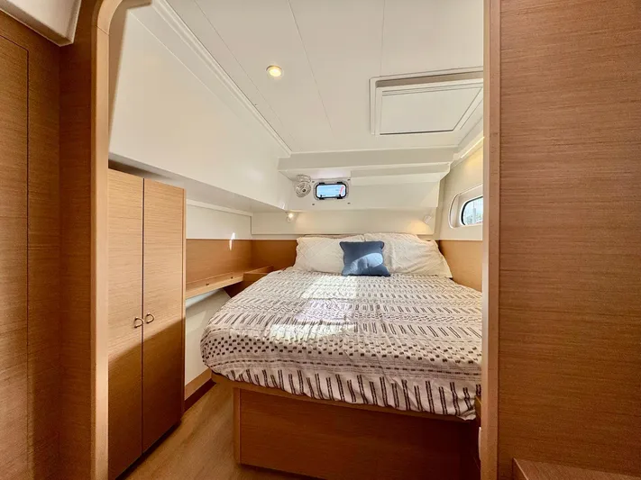 Sea SeÑora Yacht Photos Pics Luxurious cabin interior of 2023 Excess 12 yacht with cozy bed and wooden finishes.