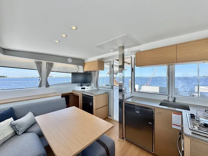 Sea SeÑora Yacht Photos Pics Modern interior of 2023 Excess 12 yacht with kitchen and seating area, overlooking the ocean.