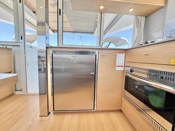 Sea SeÑora Yacht Photos Pics Modern kitchen interior on 2023 Excess 12 yacht, featuring stainless steel appliances and wood finish.