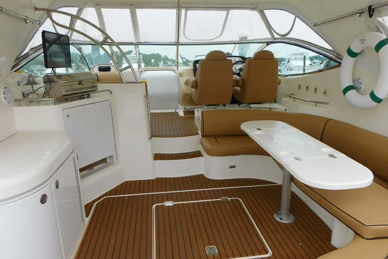 Just One More Yacht Photos Pics 2005 Cruisers Yachts 520 Express interior with seating, table, and helm.