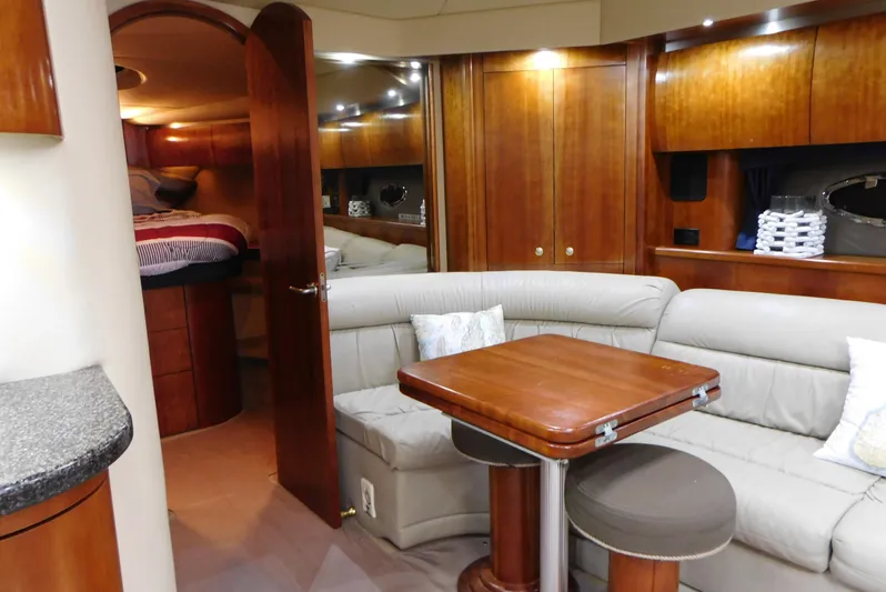 Just One More Yacht Photos Pics Luxurious interior of 2005 Cruisers Yachts 520 Express with elegant wood finishes and cozy seating.
