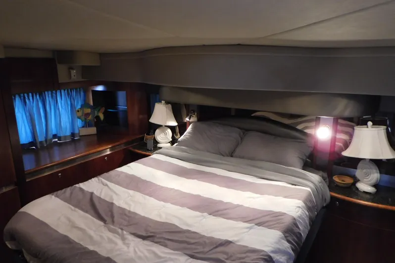 Just One More Yacht Photos Pics Luxurious bedroom interior of 2005 Cruisers Yachts 520 Express with cozy bedding and elegant lighting.