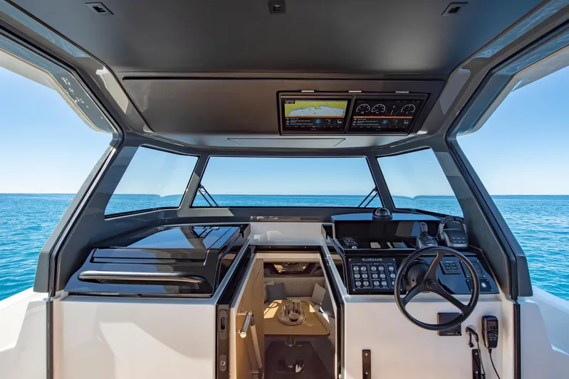 Bg42-49 Yacht Photos Pics 2023 Bluegame BG42 yacht cockpit with modern navigation system, overlooking the ocean.