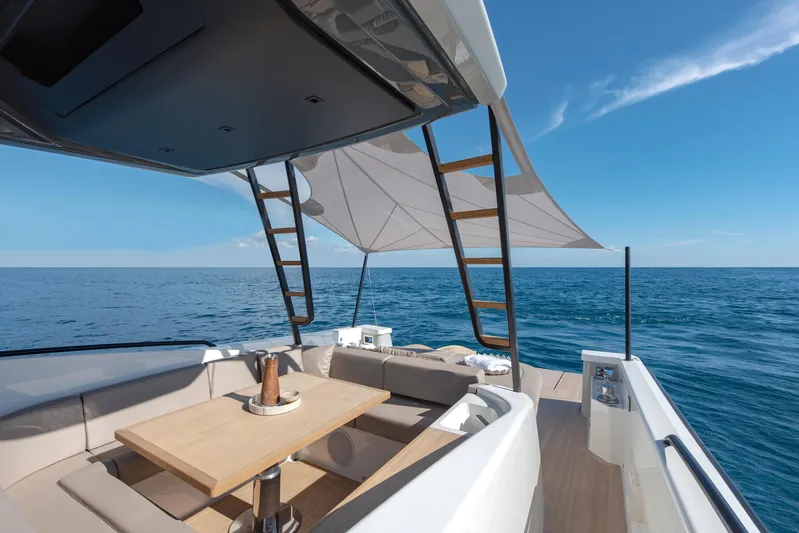 Bg42-49 Yacht Photos Pics 2023 Bluegame BG42 yacht with shaded deck, ocean view, and elegant seating area.