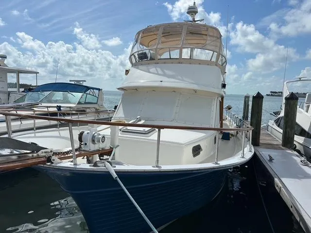 Blue Yacht Photos Pics 1987 Albin Double Cabin boat docked under a bright blue sky.