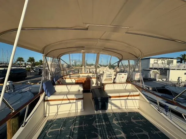 Blue Yacht Photos Pics 1987 Albin Double Cabin yacht interior with seating, helm, and canopy at marina.