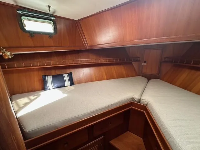 Blue Yacht Photos Pics 1987 Albin Double Cabin interior with wooden finish and cozy sleeping area.