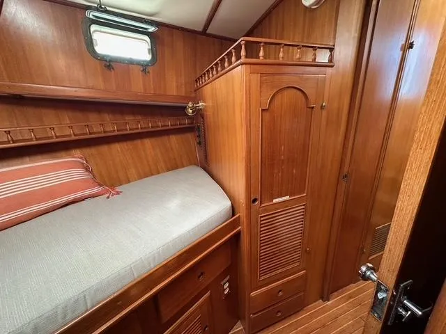 Blue Yacht Photos Pics 1987 Albin Double Cabin interior with wooden finish and cozy bed.
