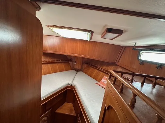 Blue Yacht Photos Pics 1987 Albin Double Cabin interior with wooden finish and cozy sleeping area.