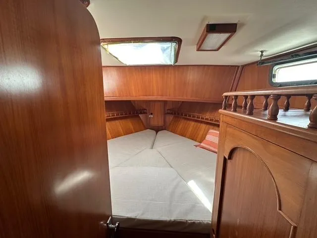 Blue Yacht Photos Pics 1987 Albin Double Cabin interior with wooden finish and cozy sleeping area.