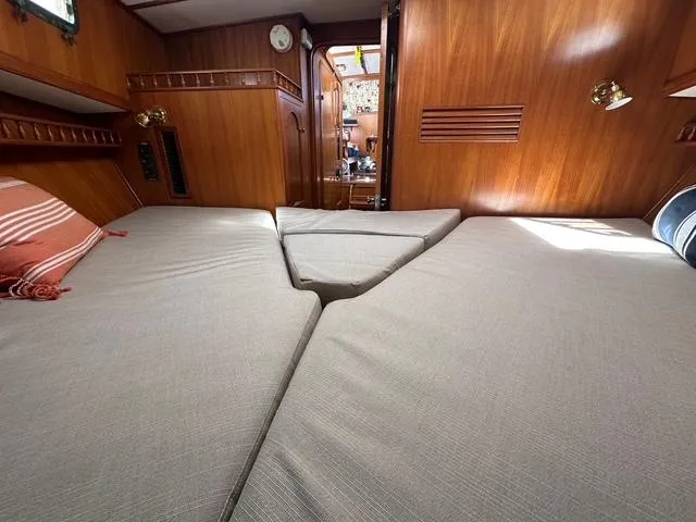 Blue Yacht Photos Pics 1987 Albin Double Cabin interior with wooden paneling and comfortable bedding.