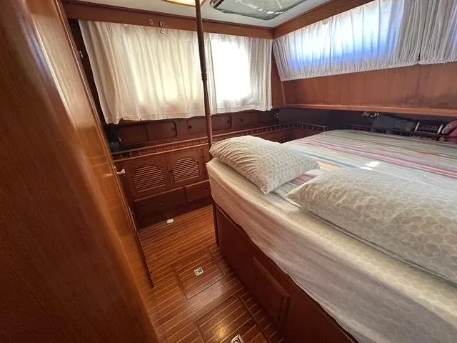 Blue Yacht Photos Pics 1987 Albin Double Cabin interior with wood paneling and cozy bed setup.