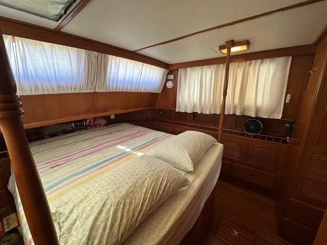 Blue Yacht Photos Pics 1987 Albin Double Cabin interior with cozy bed, wooden paneling, and soft lighting.