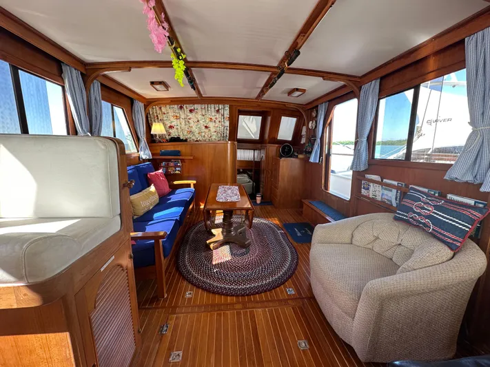 Blue Yacht Photos Pics 1987 Albin Double Cabin interior with cozy seating, wooden accents, and nautical decor.