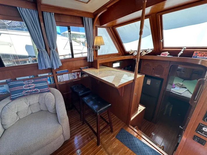 Blue Yacht Photos Pics 1987 Albin Double Cabin interior with cozy seating, wooden decor, and nautical accents.