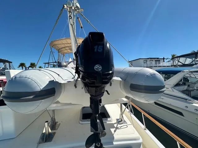 Blue Yacht Photos Pics 1987 Albin Double Cabin with inflatable boat and outboard motor on deck.