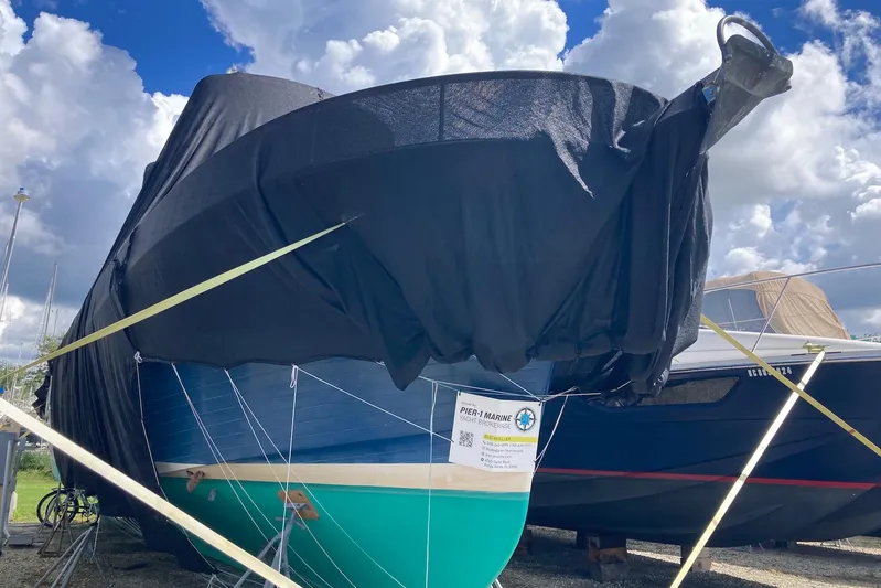 Blue Yacht Photos Pics 1987 Albin Double Cabin Trawler covered, docked under cloudy sky.