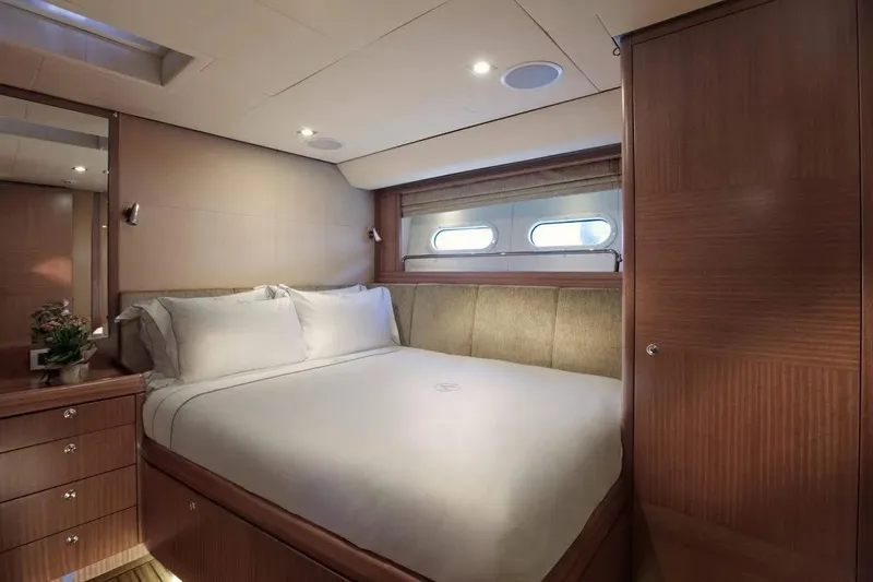 Aiyana Yacht Photos Pics Luxurious bedroom interior on 2010 Alia Yachts AIYANA, featuring elegant wood finishes and cozy bedding.