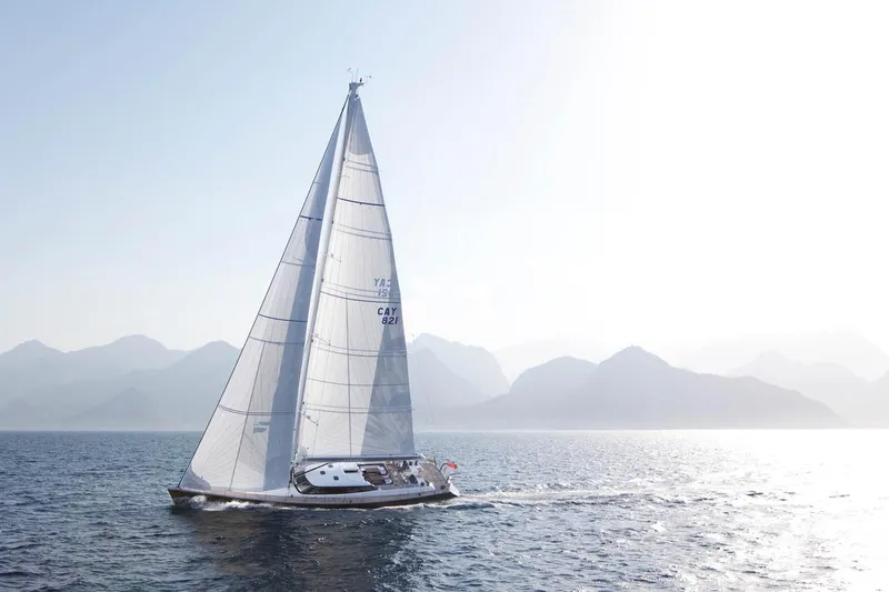 Aiyana Yacht Photos Pics Sailing yacht AIYANA by Alia Yachts, 2012, gliding on serene waters with mountainous backdrop.