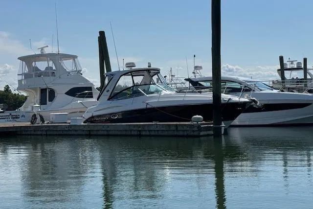 Yacht Photos Pics 2021 Monterey 335 Sport Yacht docked at marina, surrounded by other boats.