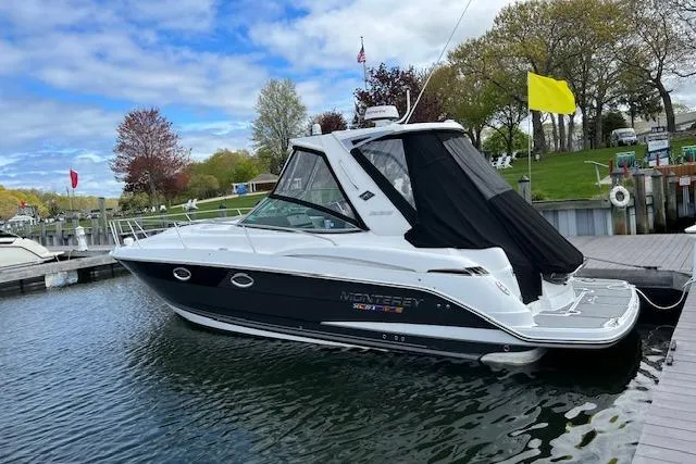  Yacht Photos Pics 2021 Monterey 335 Sport Yacht docked at a marina, featuring sleek design and modern amenities.