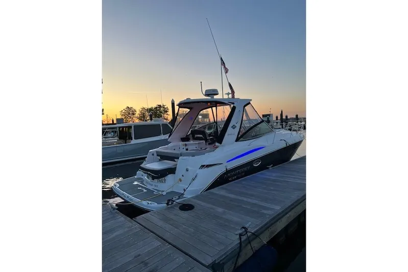  Yacht Photos Pics 2021 Monterey 335 Sport Yacht docked at sunset, showcasing sleek design and modern features.
