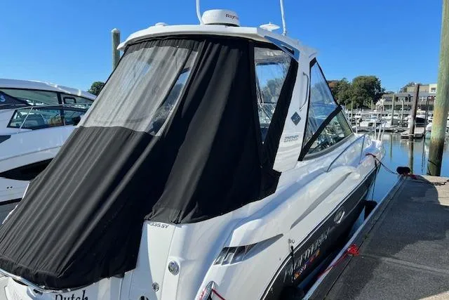  Yacht Photos Pics 2021 Monterey 335 Sport Yacht docked, featuring sleek design and black canopy.