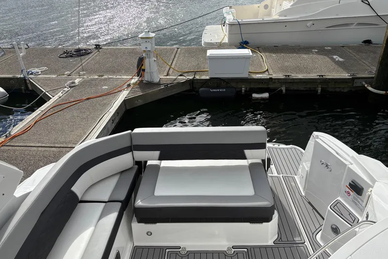  Yacht Photos Pics 2021 Monterey 335 Sport Yacht at dock, featuring sleek seating and modern design.