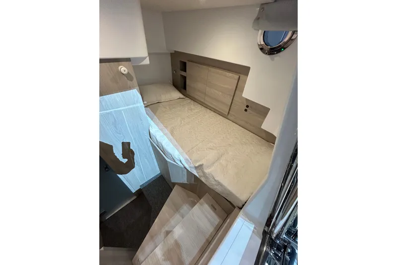 Yacht Photos Pics 2024 Azimut Fly 68 yacht interior cabin with bed and porthole window.