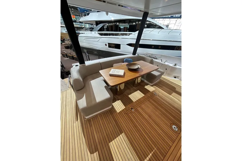  Yacht Photos Pics Luxurious 2024 Azimut Fly 68 yacht deck with elegant seating and wooden table.
