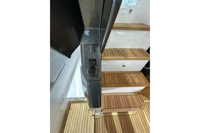  Yacht Photos Pics Staircase on 2024 Azimut Fly 68 yacht with wooden steps and control panel.